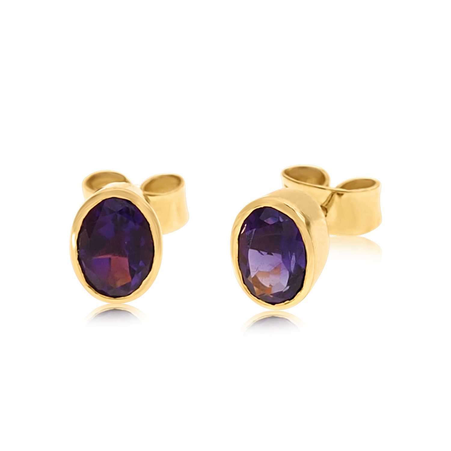 Lot 629 - Pair of 18K Gold Amethyst Solitaire Ear Studs