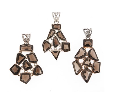 Lot 559 - Three Smoky Topaz and Silver Pendants