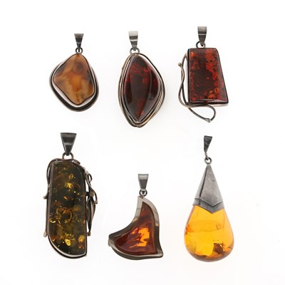 Lot 271 - Six Amber and Sterling Silver Pendants.