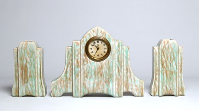 Lot 838 - An Art Deco Style Ceramic Mantel Clock with Two Vases