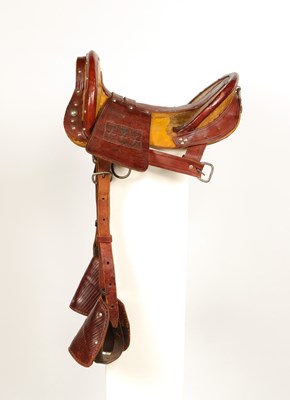 Lot 520 - Early leather saddle with leather and metal stirrups