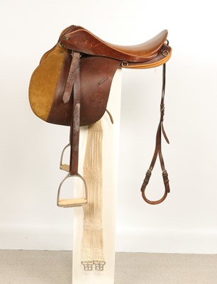 Lot 524 - Leather all purpose saddle, with metal stirrups