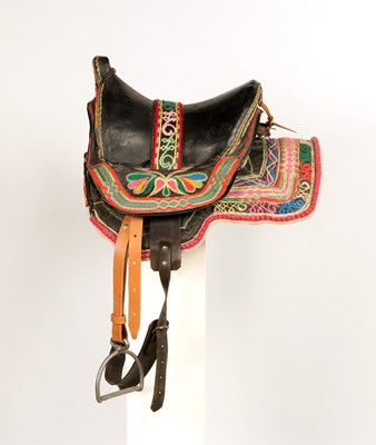 Lot 527 - Antique riding saddle, with stirrups and decorated with multicolored embroidery