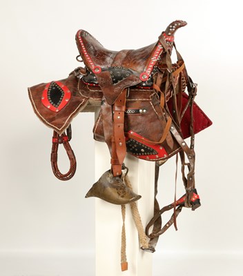 Lot 528 - Antique leather saddle, with brass stirrups and decorated with studs