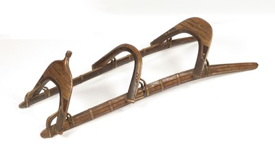 Lot 545 - A wood and brass Mahawi (Camel Saddle) with enforced curved wood rails