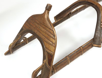 Lot 545 - A wood and brass Mahawi (Camel Saddle) with enforced curved wood rails