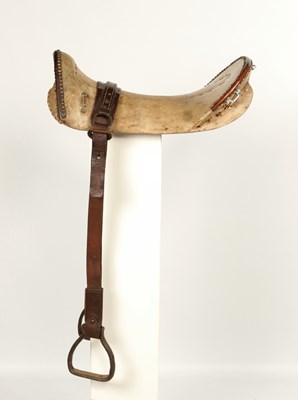 Lot 547 - South American leather saddle, with metal stirrups