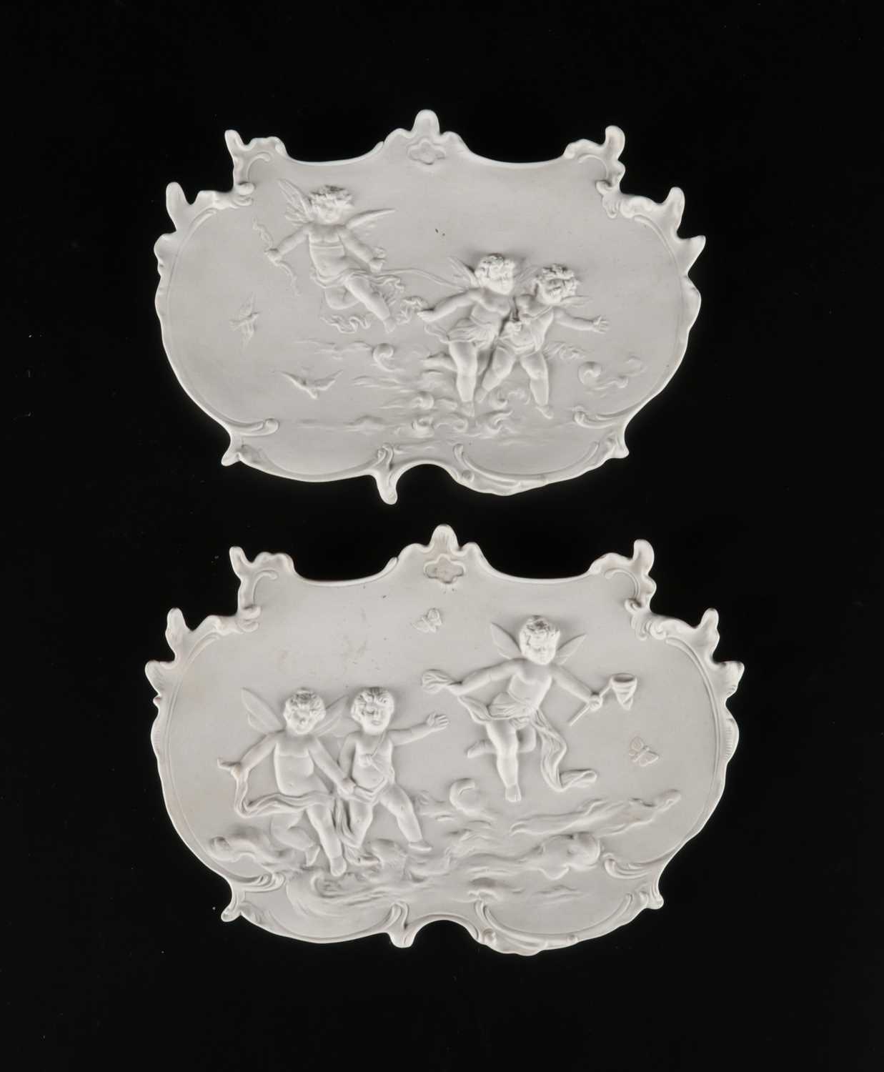 Lot 87 - Pair of Bisque Porcelain Plaques with Putti.